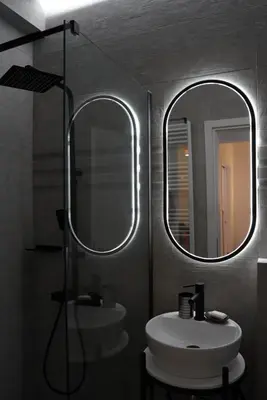 a bathroom with two mirrors and a sink at Bright & Cozy Apartment, Athens in Athens