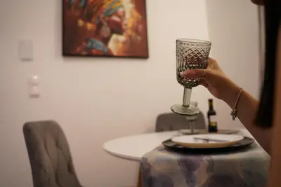 a person holding a wine glass on a table at Bright & Cozy Apartment, Athens in Athens