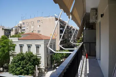 a balcony with a view of a building at Bright & Cozy Apartment, Athens in Athens