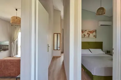 a bedroom with a bed and a hallway at D & K Vacation Villa Anavissos in Anavissos