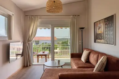 a living room with a couch and a table at D & K Vacation Villa Anavissos in Anavissos