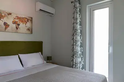 a bedroom with a bed and a window at D & K Vacation Villa Anavissos in Anavissos