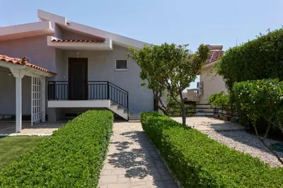 a house with a walkway in front of it at D & K Vacation Villa Anavissos in Anavissos