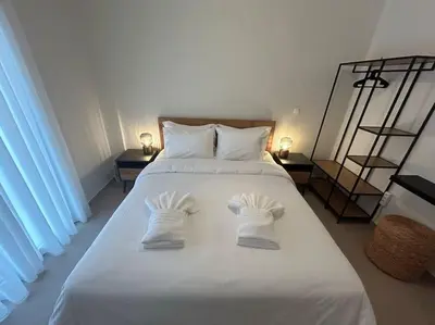 a white bed with two pairs of underwear on it at Urban Escape in Athens