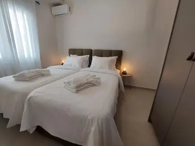 a bedroom with two beds with white sheets at Urban Escape in Athens