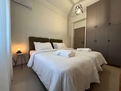 a bedroom with two beds with white sheets at Urban Escape in Athens