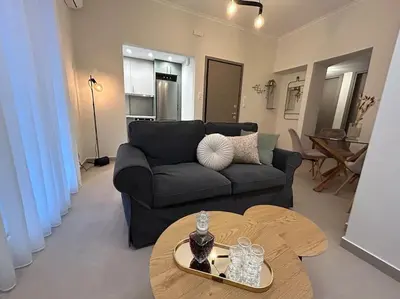 a living room with a couch and a table at Urban Escape in Athens
