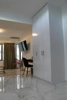 a living room with a large white cabinet and a desk at Syntagma Luxury Suites by CK-2 in Athens