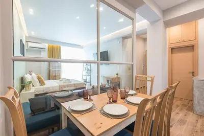a dining room with a table and chairs and a living room at Top Ten Apartment 4 in Athens