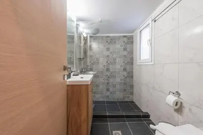 a bathroom with a sink and a toilet at Top Ten Apartment 4 in Athens