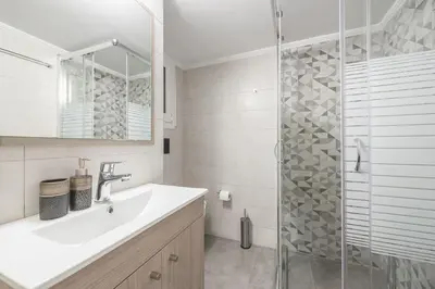 a bathroom with a sink and a glass shower at Top Ten Lux in Athens