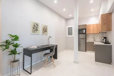 a kitchen with a desk and a table in a room at Top Ten Lux in Athens