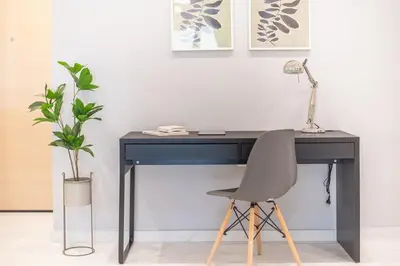 a black desk with a chair and a plant at Top Ten Lux in Athens