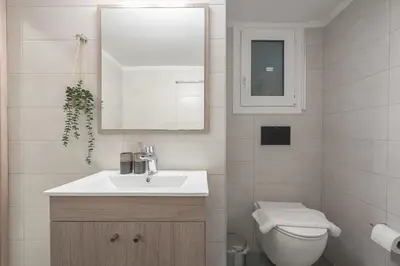 a bathroom with a sink and a toilet and a mirror at Top Ten Lux in Athens