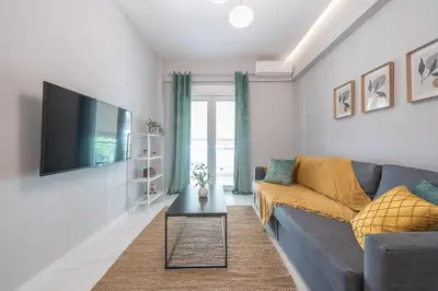 a living room with a couch and a tv at Top Ten Lux in Athens
