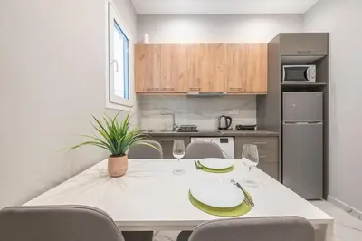 a kitchen with a white table with bananas on it at Athens Stay in Athens
