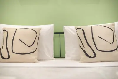 a bed with two pillows on top of it at Athens Stay in Athens