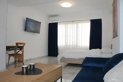 a bedroom with a bed and a table in a room at Syntagma Luxury Suites by CK-3 in Athens