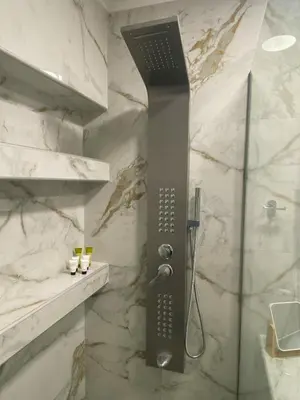 a shower with a black shower head in a bathroom at Syntagma Luxury Suites by CK-3 in Athens