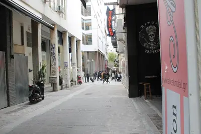 an empty alley with people walking down the street at Syntagma Luxury Suites by CK-3 in Athens