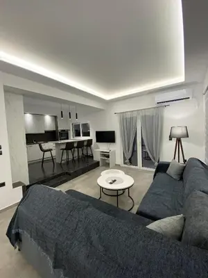 a living room with a couch and a table at Anafis Exclusive in Athens