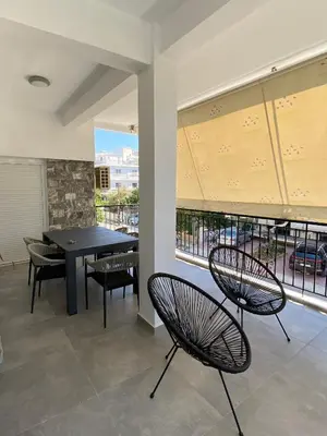a dining room with a table and chairs and a window at Anafis Exclusive in Athens