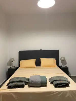 a bed with two pillows and towels on it at Anafis Exclusive in Athens