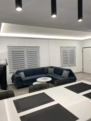 a living room with a blue couch and a table at Anafis Exclusive in Athens
