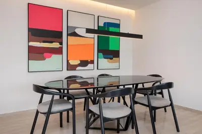 a dining room with a glass table and chairs at Elegant & Central 3BR in Glyfada in Athens