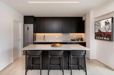 a kitchen with a island with bar stools at Elegant & Central 3BR in Glyfada in Athens