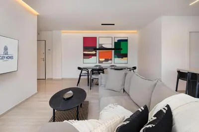 a living room with a couch and a table at Elegant & Central 3BR in Glyfada in Athens
