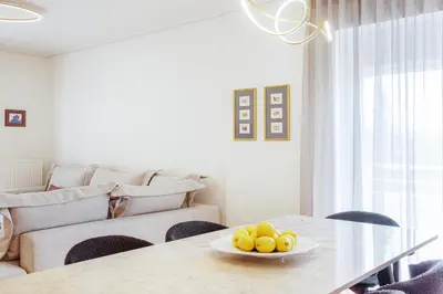 a living room with a table with a bowl of fruit on it at Bright and Luxurious 2BR Home in Central Glyfada in Athens