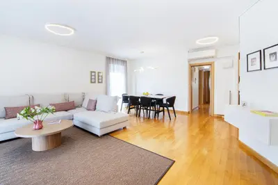 a living room with a white couch and a table at Bright and Luxurious 2BR Home in Central Glyfada in Athens