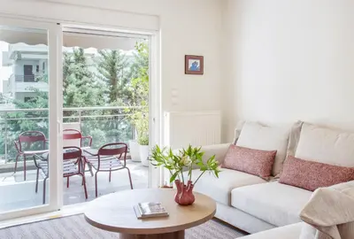 a living room with a couch and a table at Bright and Luxurious 2BR Home in Central Glyfada in Athens