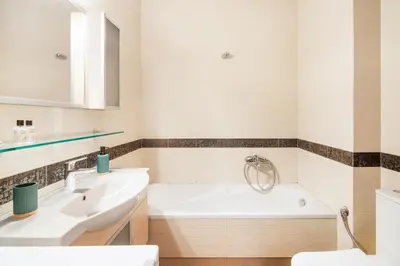 a bathroom with a white tub and a sink at Bright and Luxurious 2BR Home in Central Glyfada in Athens