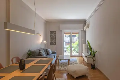 a living room with a table and a couch at Empyrean Apartment in Athens