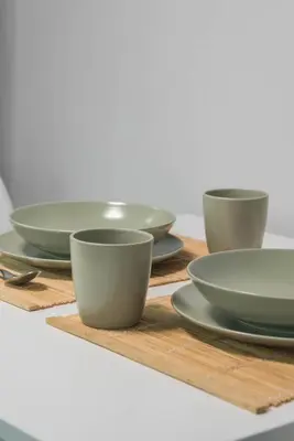 a group of bowls and plates on a wooden table at Empyrean Apartment in Athens