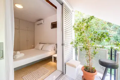 a small bedroom with a bed and a balcony at Very comfortable, close to Acropolis in Athens