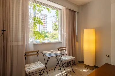 a table and two chairs in a room with a window at Very comfortable, close to Acropolis in Athens