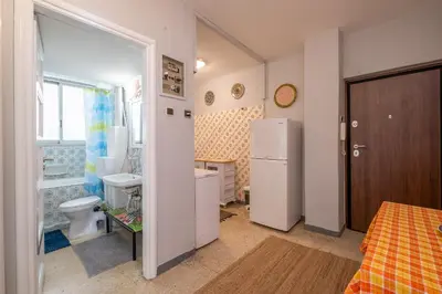 a bathroom with a toilet and a sink and a refrigerator at Very comfortable, close to Acropolis in Athens