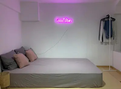 a bedroom with a bed with a neon sign on the wall at TINY STUDIOS Under the Akropolis -1- in Athens