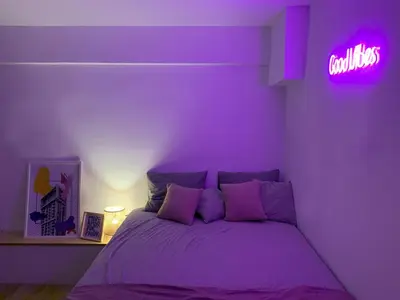 a purple bedroom with a bed and a neon sign at TINY STUDIOS Under the Akropolis -1- in Athens