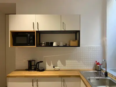 a kitchen with a sink and a microwave at TINY STUDIOS Under the Akropolis -1- in Athens