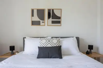 a bedroom with a bed with white sheets and pillows at Graceful 2BR Apartment in Paleo Faliro by UPSTREET in Athens