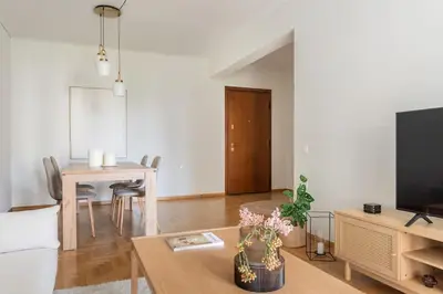 a living room with a table and a tv at Graceful 2BR Apartment in Paleo Faliro by UPSTREET in Athens
