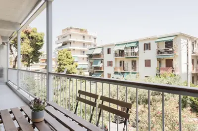 a balcony with a bench and a view of buildings at Graceful 2BR Apartment in Paleo Faliro by UPSTREET in Athens