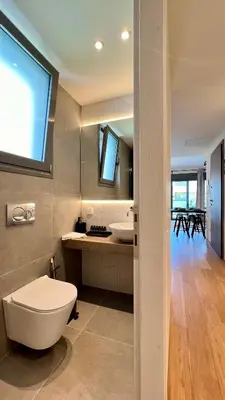a bathroom with a toilet and a sink at Orfeos A2 Modern Retreat in Glyfada in Athens