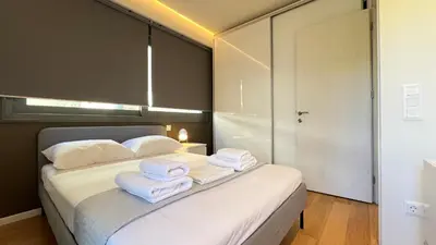 a bedroom with a bed with towels on it at Orfeos A2 Modern Retreat in Glyfada in Athens