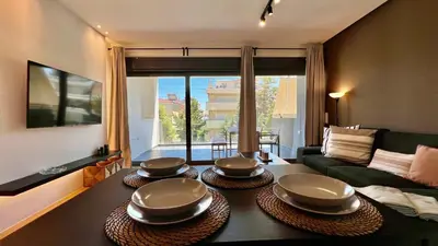 a living room with three bowls on top of a table at Orfeos A2 Modern Retreat in Glyfada in Athens