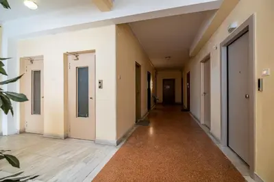 an empty hallway of a house with white walls and wooden floors at Luxurious Studio in the Heart of Athens in Athens
